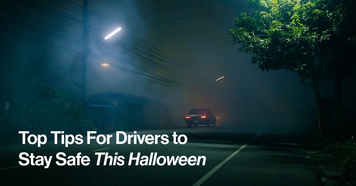 The article title over a car driving on Halloween night, disappearing into fog.