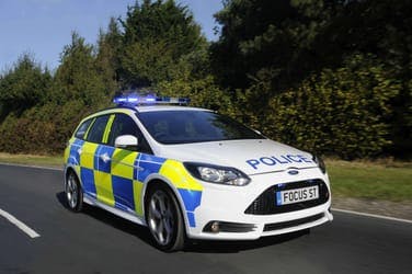 The article over a police car with lights flashing, looking for drivers with penalty points.