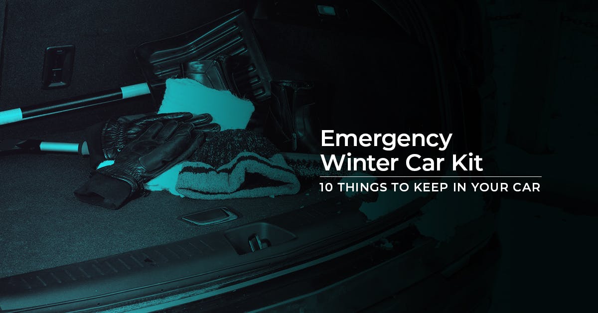The article title over the boot of a car, filled with emergency winter car kit items, like gloves.