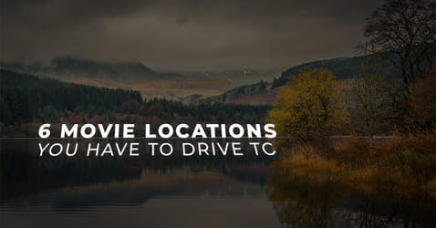 The article title over a movie location, a serene lake with mountains and trees in the background. 
