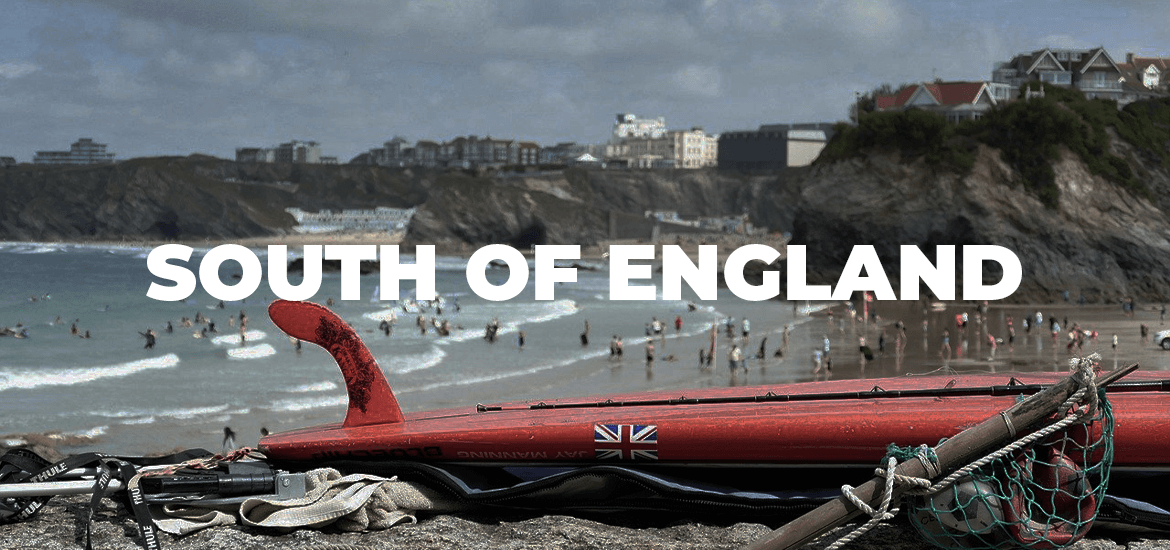 red paddleboard in foreground and South of England seaside town in background with blog title on top