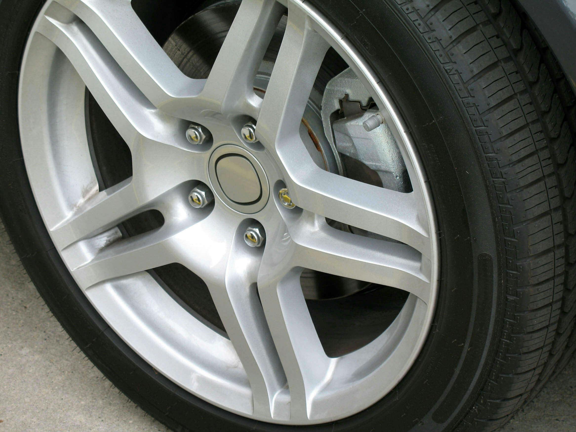 A brand new tyre with a shiny silver alloy wheel.