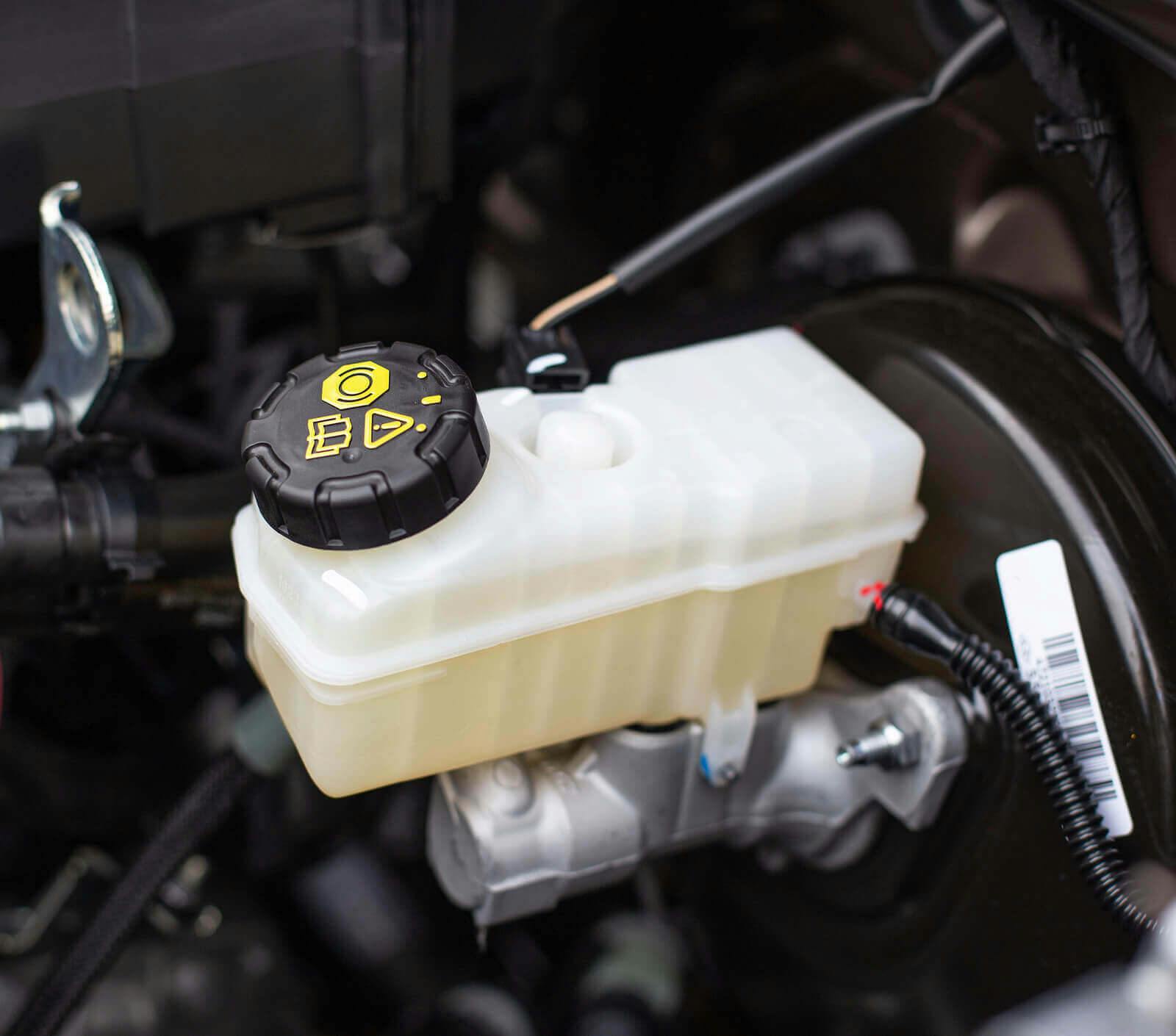 A brake fluid reservoir inside a car engine. 