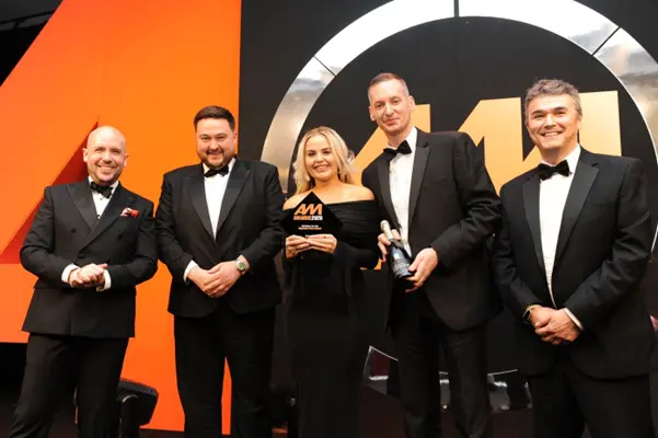 Toby Hughes presenting Workshop of the Year award 2025 at Automotive Magazine (AM) awards alongside comedian Tom Allen.