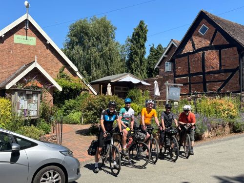 Ollie and friends on bikes outside a pub on the journey