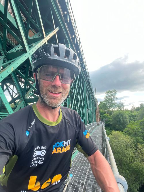 Ollie stood on a bridge taking a selfie during his journey
