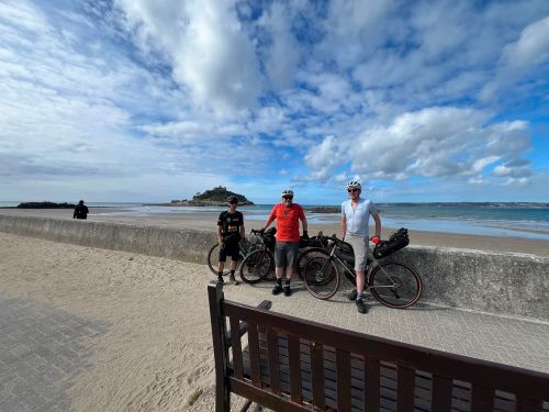 Ollie and friends stood in front of Saint Michael's Mount during their epic LEJOG journey