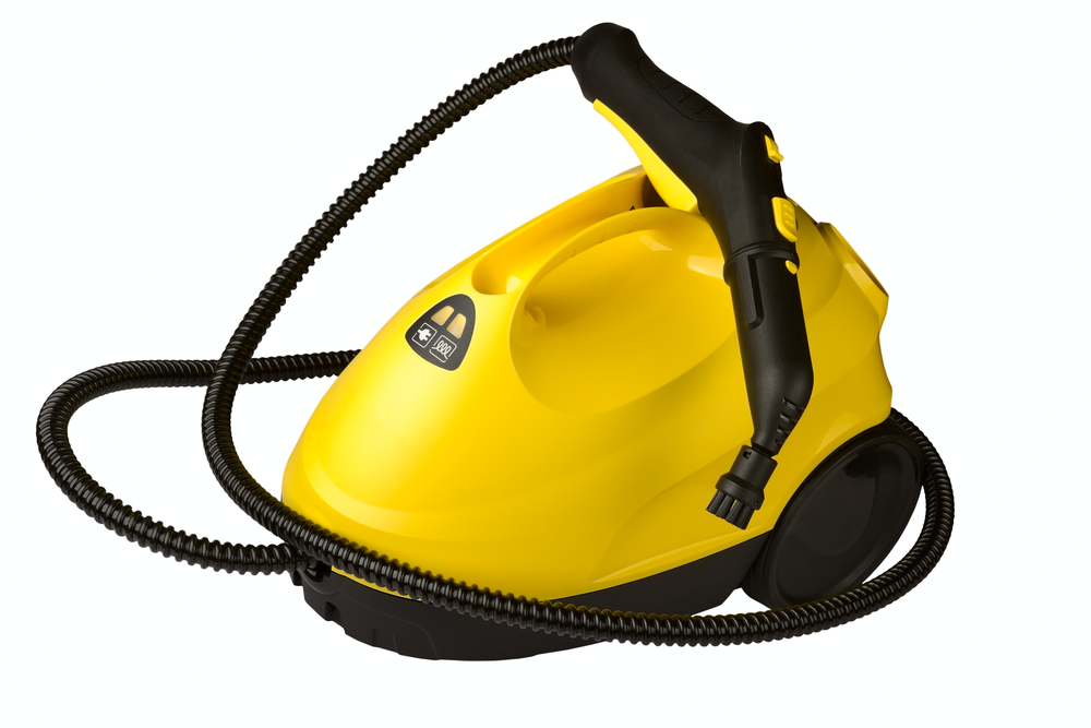 yellow and black steam cleaner, bulky cleaning machine on wheels with nozzle