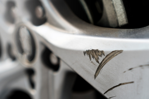 Close up shot of an alloy wheel with a large scratch